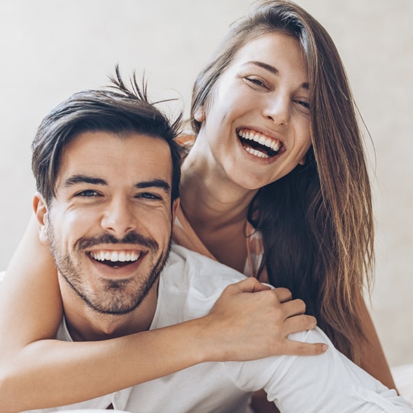 A young couple showing off their new smiles