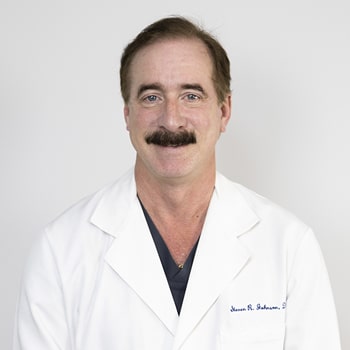 Dr. Steven Johnson wearing his dental coat