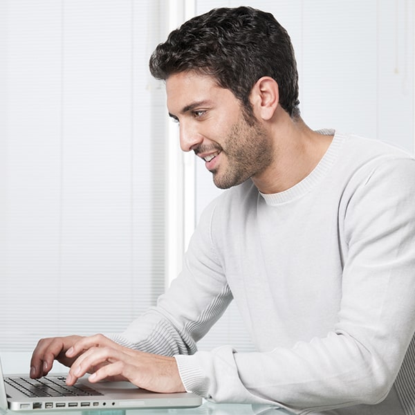 A young man reviewing financing options on his computer