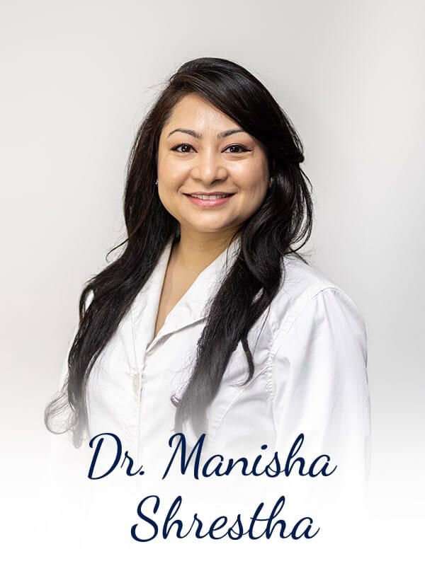 Dr. Shrestha wearing her white coat